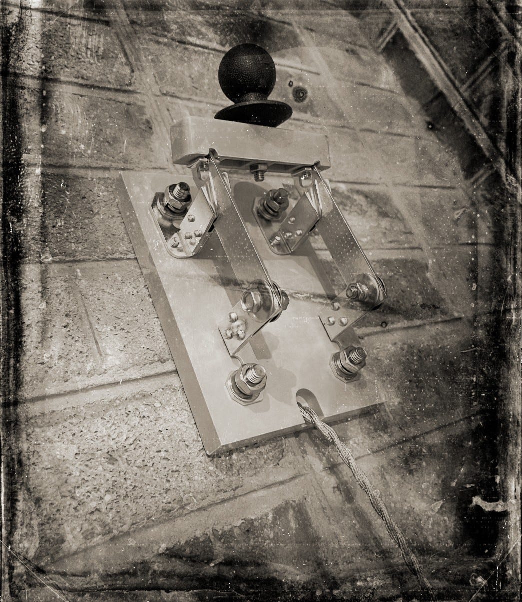 A sepia-toned photo made to look like a Victorian era daguerreotype. The photo shows an old-fashioned knife switch with a wire hanging down, connecting it to some device out of the picture.