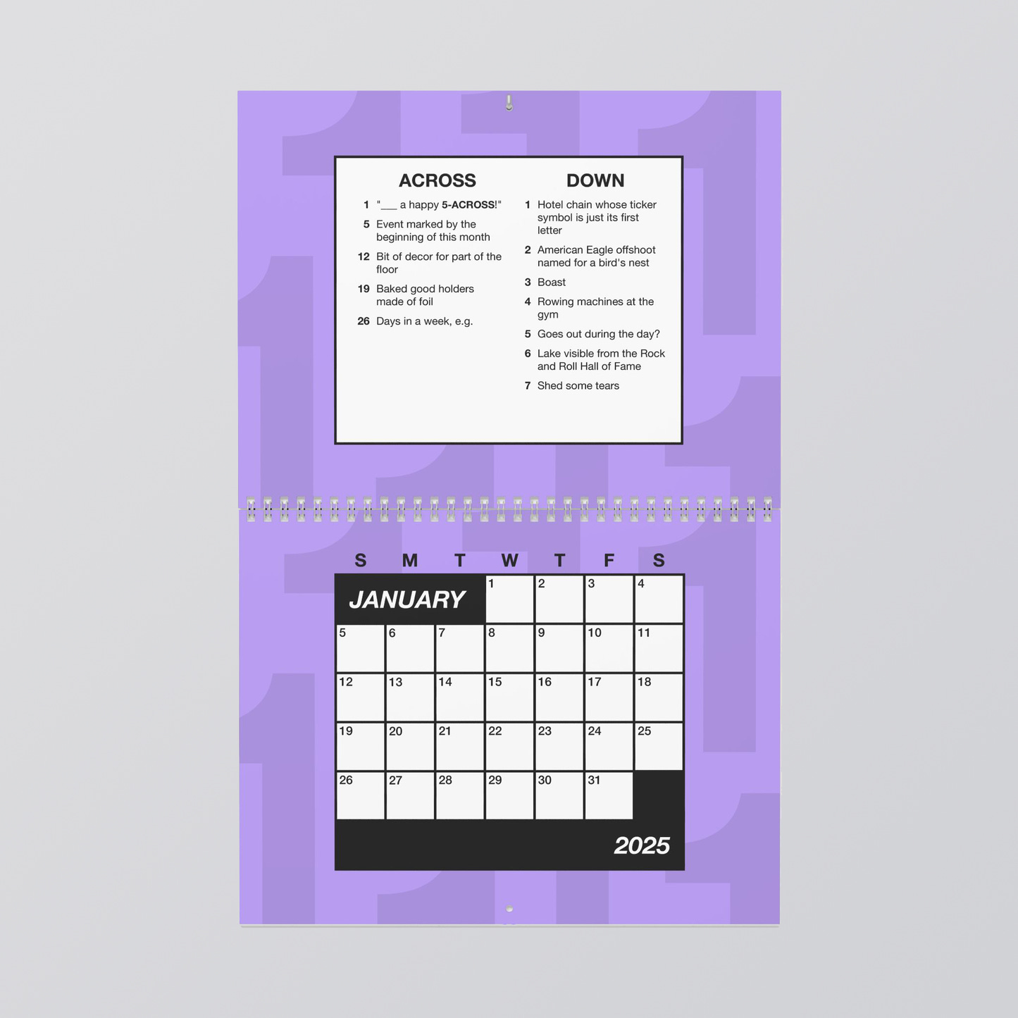  a purple calendar opened to January 2025. The bottom page is the days of the month but also a crossword grid, Above it are the clues for the month, which read: ACROSS. 1. “___a happy 5-across” 5. Event marked by the beginning of this month 12. Bit of decor for part of the floor. 19, Baked good holders made of foil. 26 Days in a week, e.g. DOWN. 1. Hotel chain whose ticker symbol is just its first letter. 2. American Eagle offshoot named for a bird’s nest. 3. Boast. 4. Rowing machines at the gym. 5 Goes out during the day? 6. Lake visible from the Rock and Roll Hall of Fame. 7, Shed some tears.