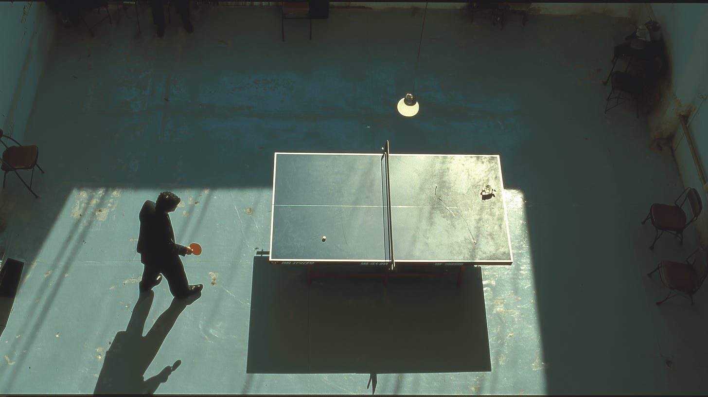 Overhead view of a lone figure holding a paddle beside a worn ping-pong table in a vast, sun-raked hall, long shadows thrown across the concrete floor and the far side of the table empty — a rally waiting for its return. Overhead view of a lone figure holding a paddle beside a worn ping-pong table in a vast, sun-raked hall, long shadows thrown across the concrete floor and the far side of the table empty — a rally waiting for its return.