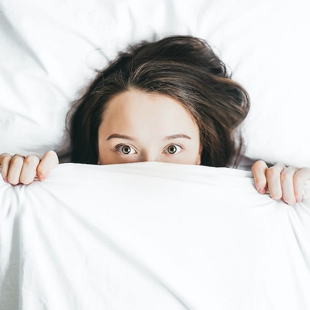 woman covering face with sheet woman covering face with sheet