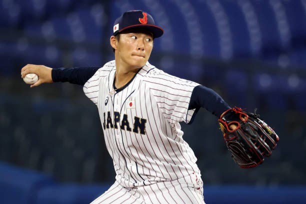 Yoshinobu Yamamoto of Team Japan pitches in the first inning against Team Republic of Korea during the semifinals of men's baseball on day twelve of...