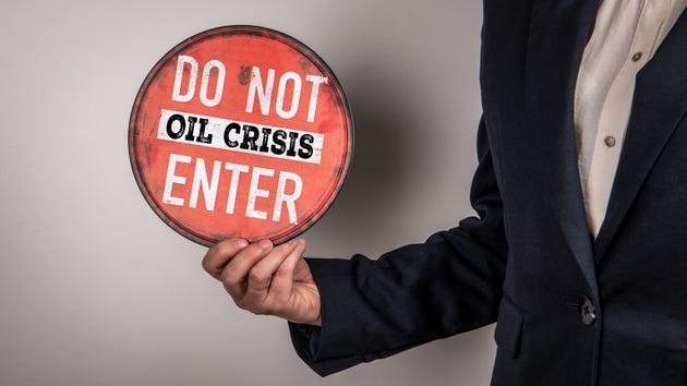 Oil Crisis Warning Sign Do Not Enter Message Held by Business Person