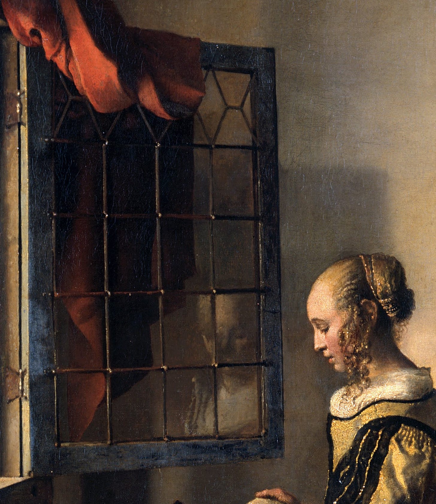 Detail of the open window: the young woman's face reflected in the leaded panes.