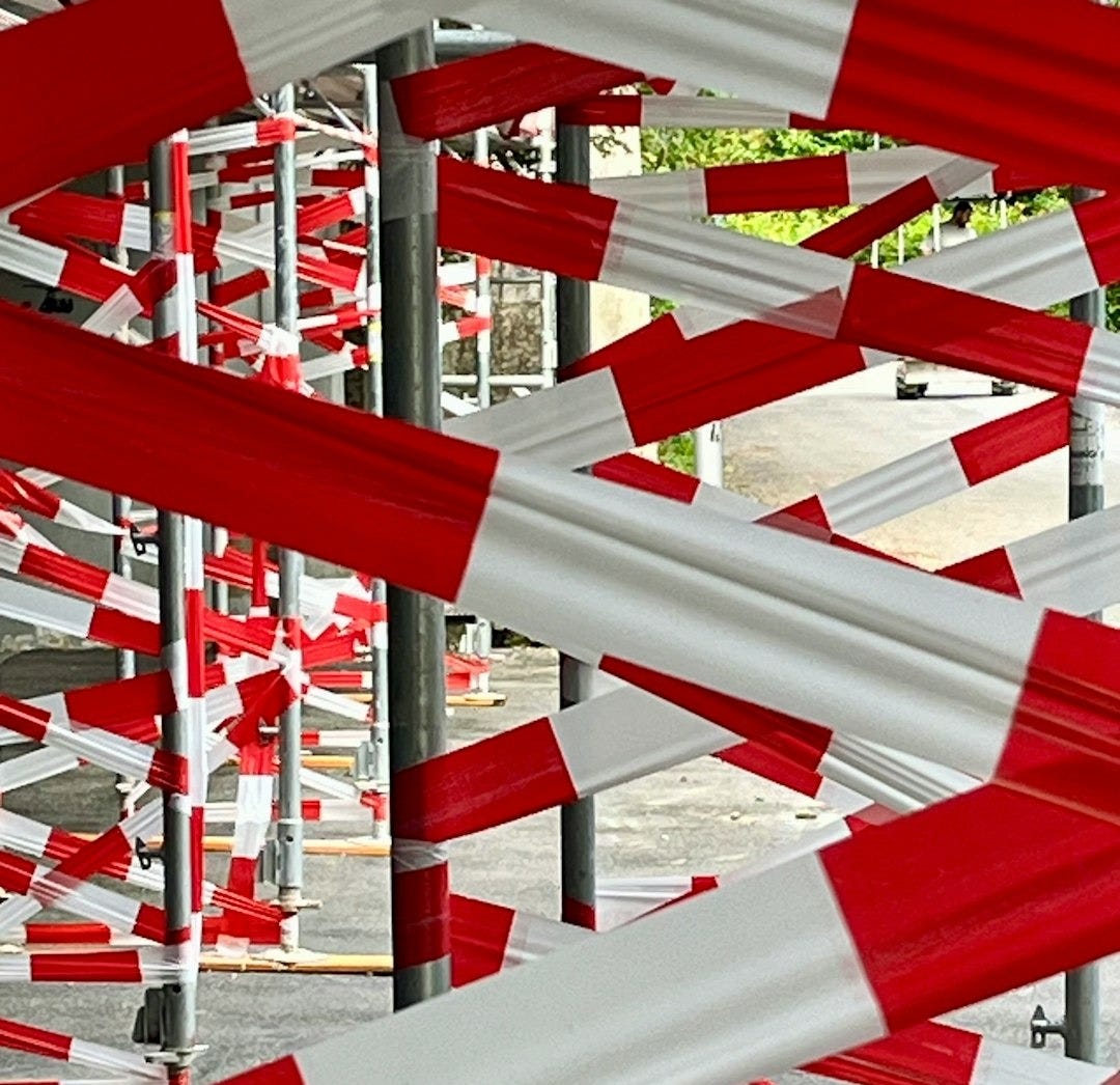 A bunch of red and white barriers in a parking lot