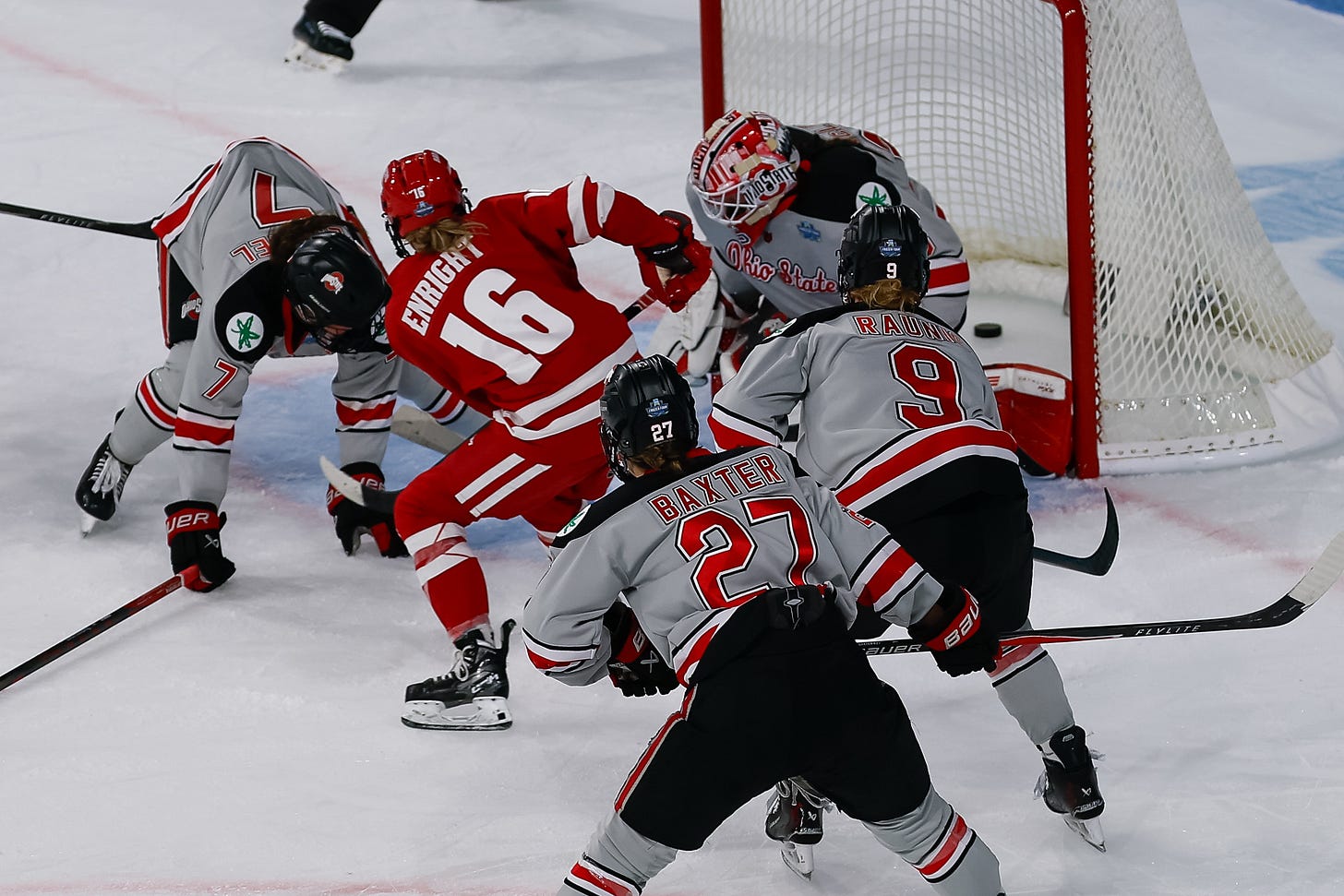Wisconsin Badgers senior Claire Enright navigates between Ohio State captain Emma Peschel and goaltender Hailey Macleod to score