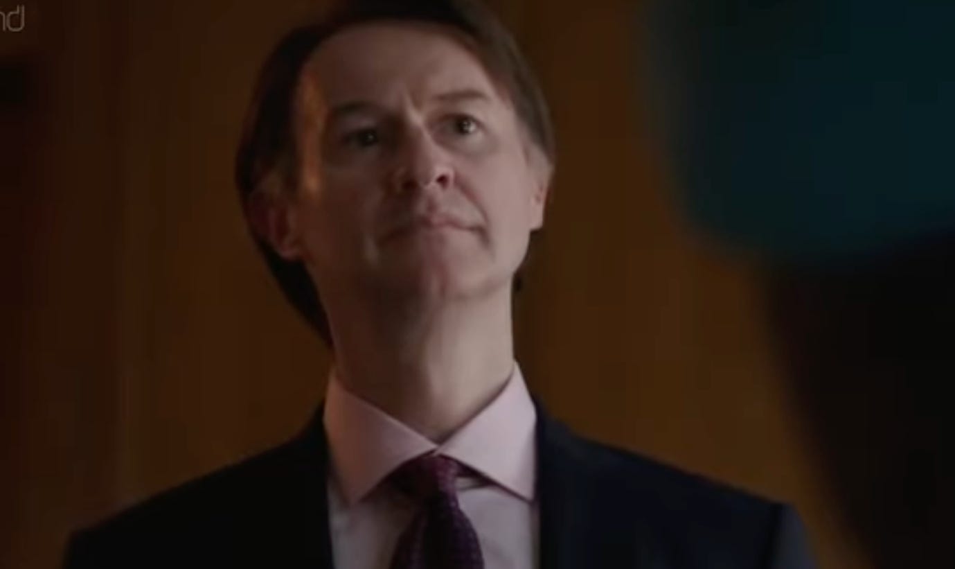 A person in a suit and tie

AI-generated content may be incorrect.