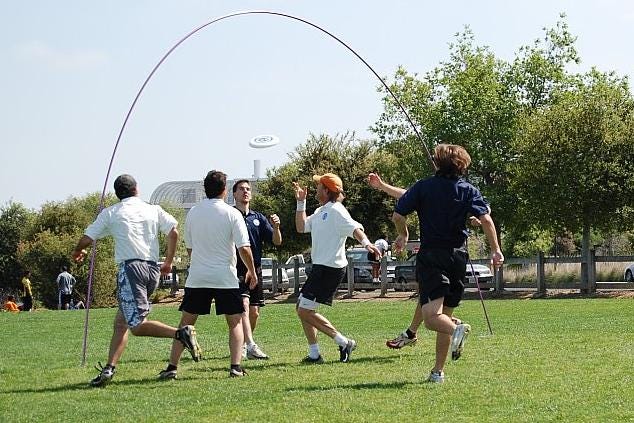 May be an image of 8 people, people playing football, track and field and frisbee
