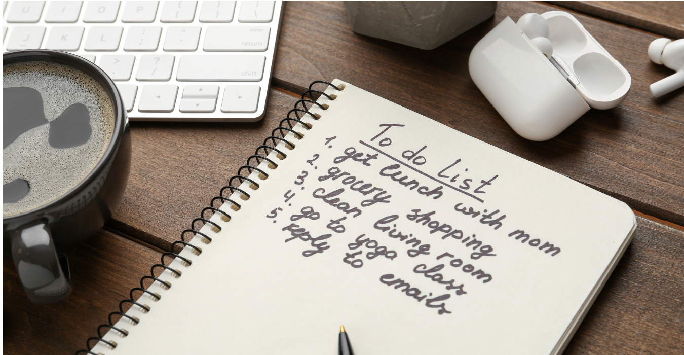 A handwritten to-do list on paper beside an untouched cup of coffee, viewed from above on a clean surface. A handwritten to-do list on paper beside an untouched cup of coffee, viewed from above on a clean surface.