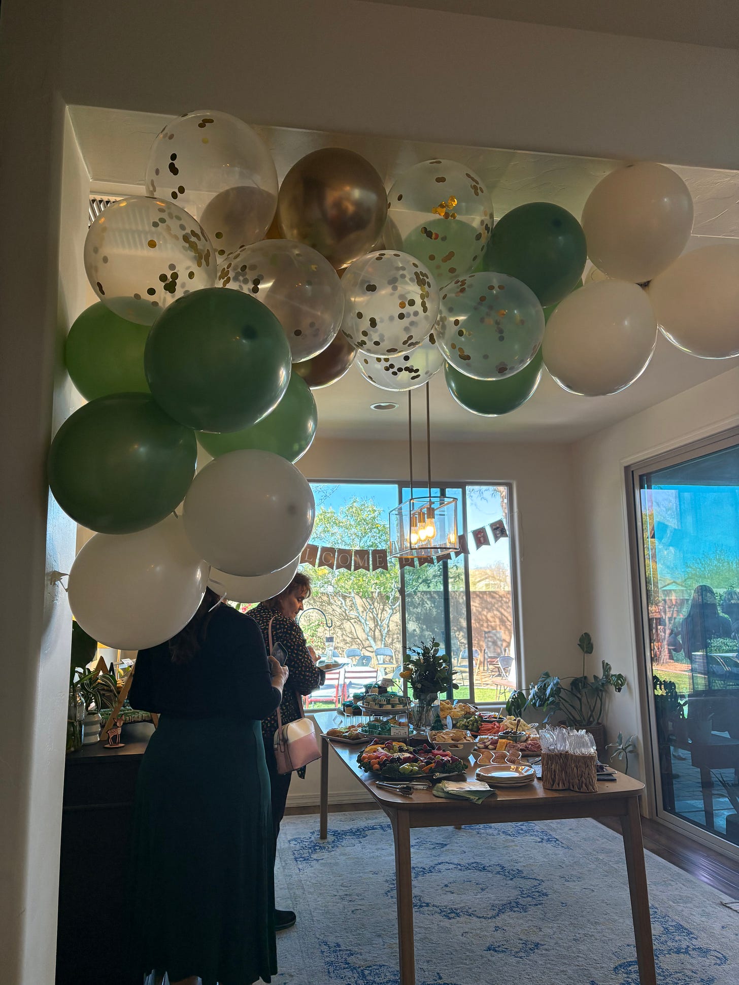 party table with food with balloons