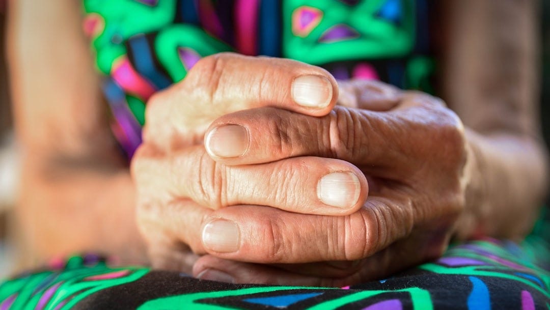 a close up of a person holding their hands together