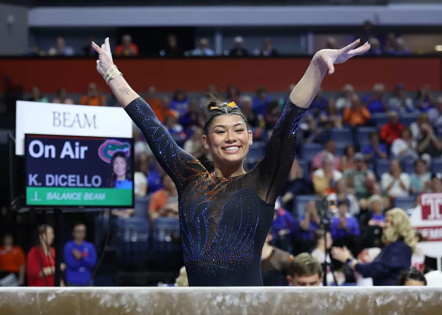 Kayla DiCello saluting after her beam routine