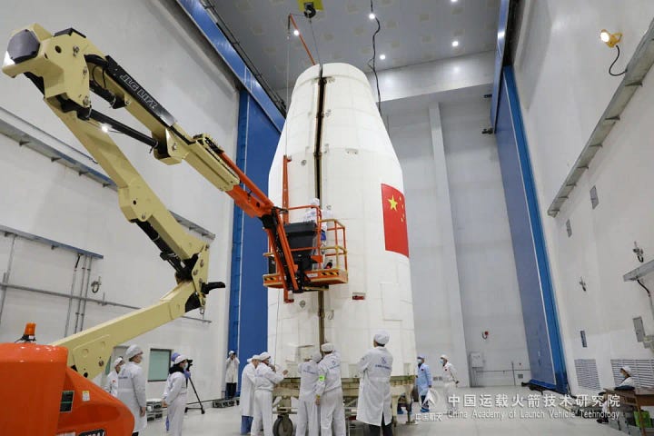 The Long March 2C's fairing, sporting the Algerian flag, encapsulating AlSat-3A and being placed atop of the launch vehicle.