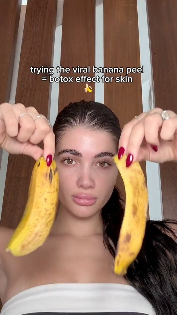 A woman holding bananas over her face as part of a skincare trend on TikTok A woman holding bananas over her face as part of a skincare trend on TikTok
