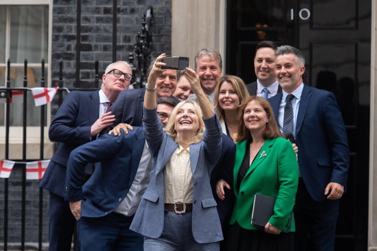 People taking group selfie People taking group selfie