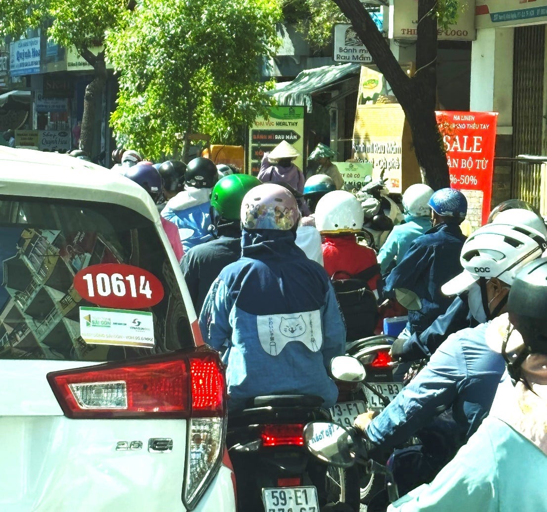 A group of people on motorcycles in a busy street

Description automatically generated