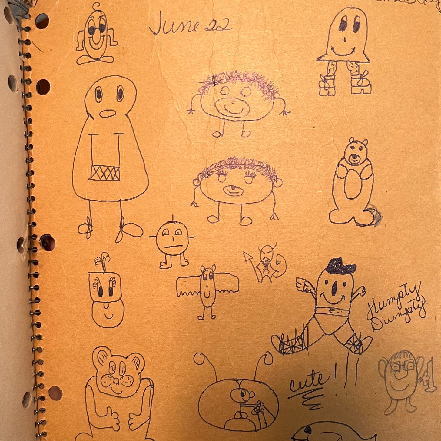 The back cover of a spiral-bound notebook, covered in doodles of cute animals and unidentifiable creatures.