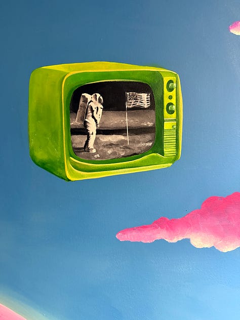 Detail shots from Pato’s mural showing two floating televisions with imagery of the moon landing and Mars, alongside a close-up of a vintage camera hanging from a saguaro arm, symbolizing media, storytelling, and perspective in journalism.