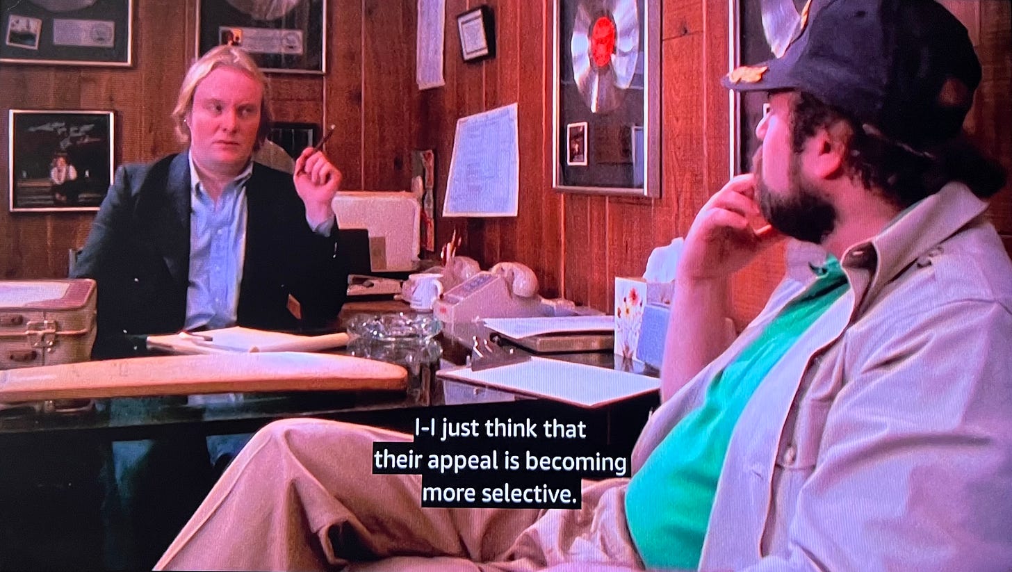 Image from This is Spinal Tap: Ian and Marty diBergi talking in Ian’s office, where when Marty asks if Spinal Tap’s popularity is waning, Ian says, “I — I just think that their appeal is becoming more selective.”