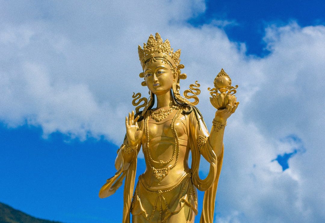 a golden statue of a woman holding a flower a golden statue of a woman holding a flower
