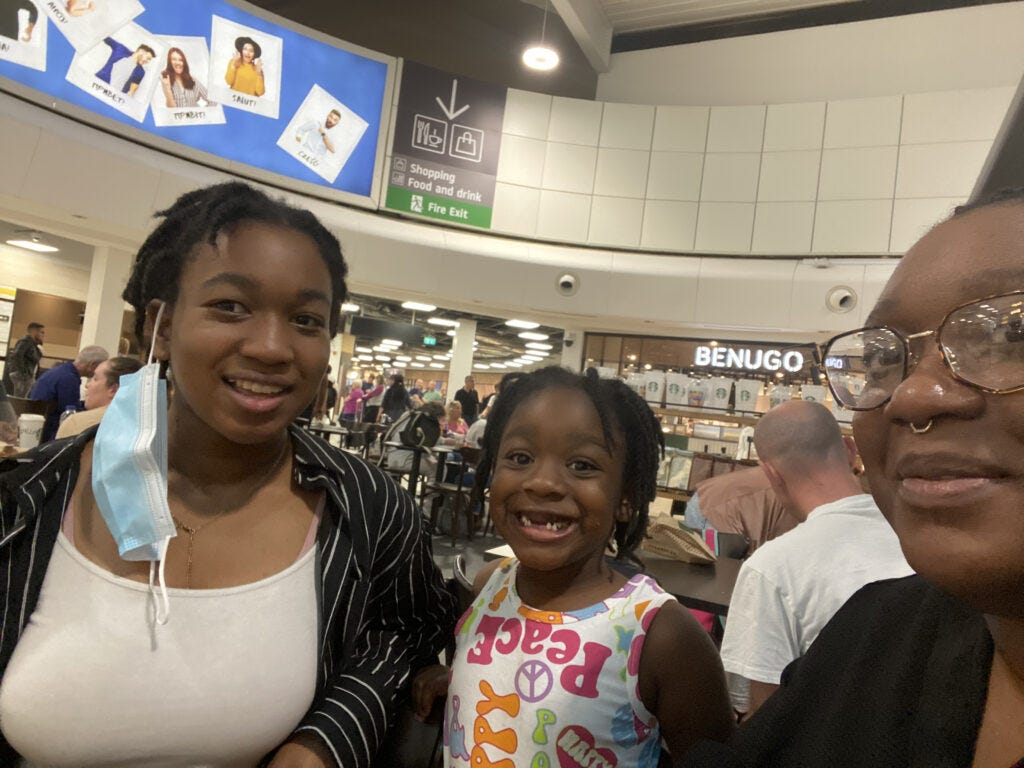 Blogger Tinuke Bernard at the airport with her daughters 2022