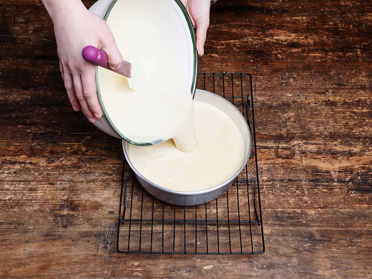 pouring flan mixture into baking dish pouring flan mixture into baking dish