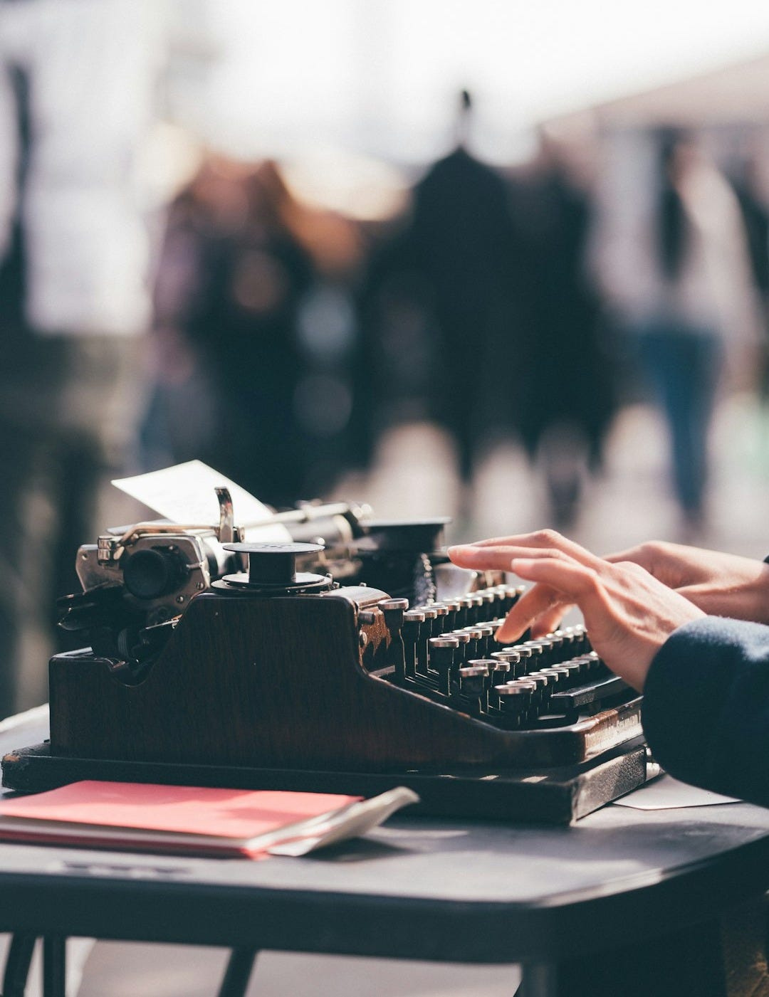 person using black typewriter person using black typewriter