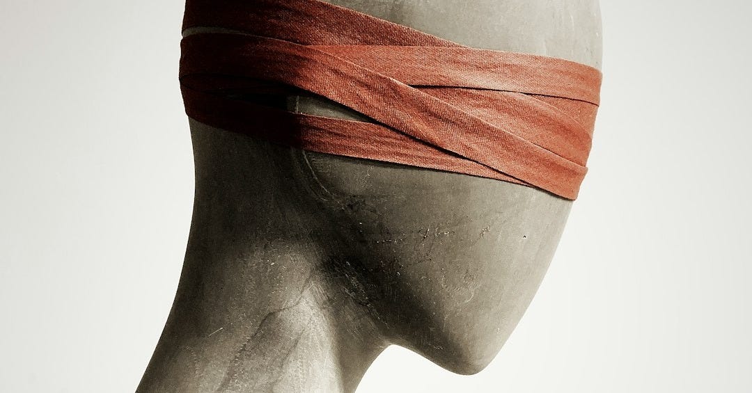 a white mannequin with a red band on its head a white mannequin with a red band on its head