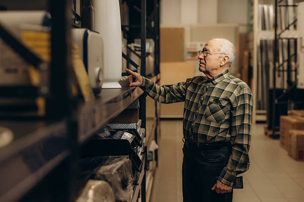 Senior man selecting products in hardware store aisle Elderly man in plaid shirt examines products on a warehouse store shelf, choosing items while shopping in a wide aisle interior aged retail inventory stock pictures, royalty-free photos & images Senior man selecting products in hardware store aisle Elderly man in plaid shirt examines products on a warehouse store shelf, choosing items while shopping in a wide aisle interior aged retail inventory stock pictures, royalty-free photos & images