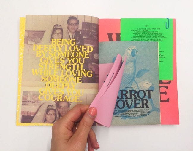 This may contain: a person holding a pink object in front of a book with an article on it