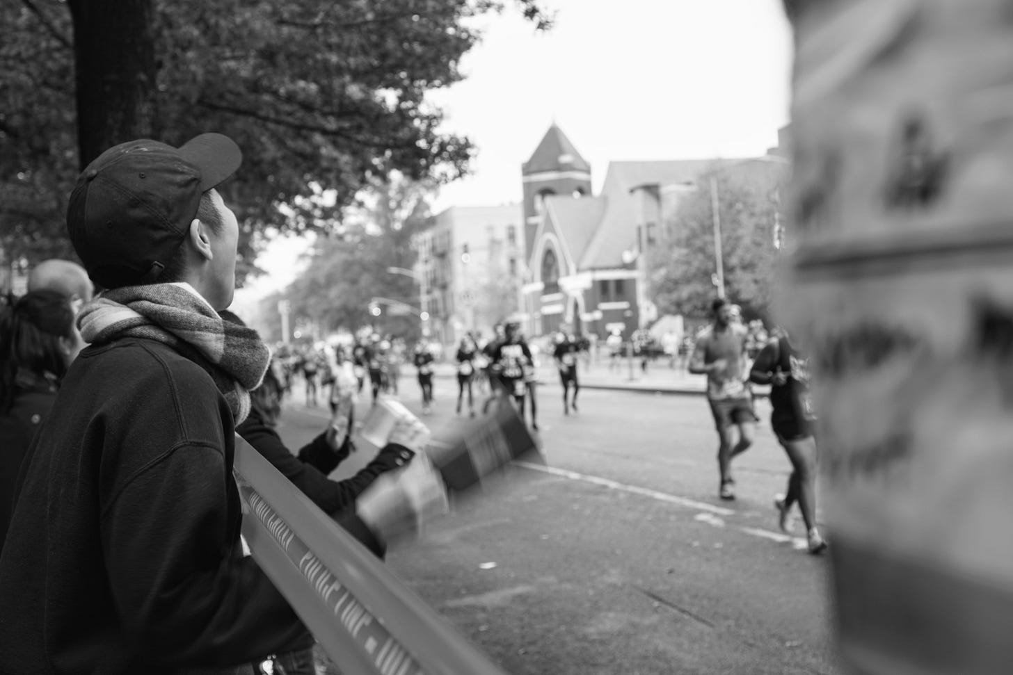 Yoko on the side of the street cheering runners on