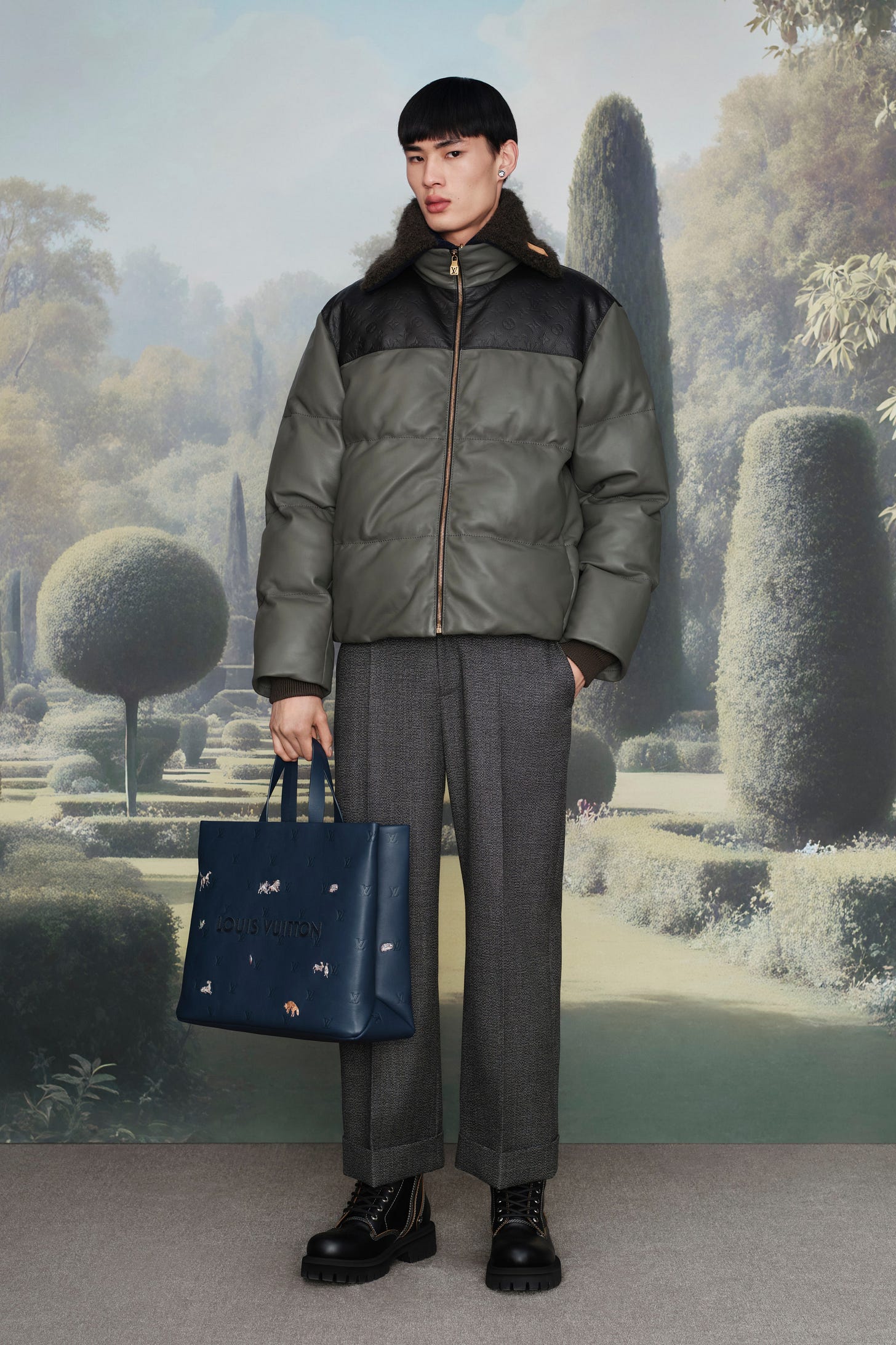 Image may contain Clothing Coat Person Standing Accessories Bag Handbag Jacket Adult Pants and Purse