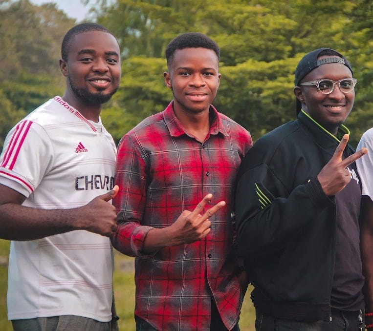 a group of men standing next to each other a group of men standing next to each other