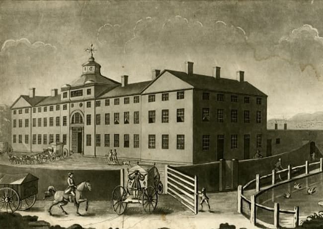 A drawing of a building with horses and carriages

Description automatically generated