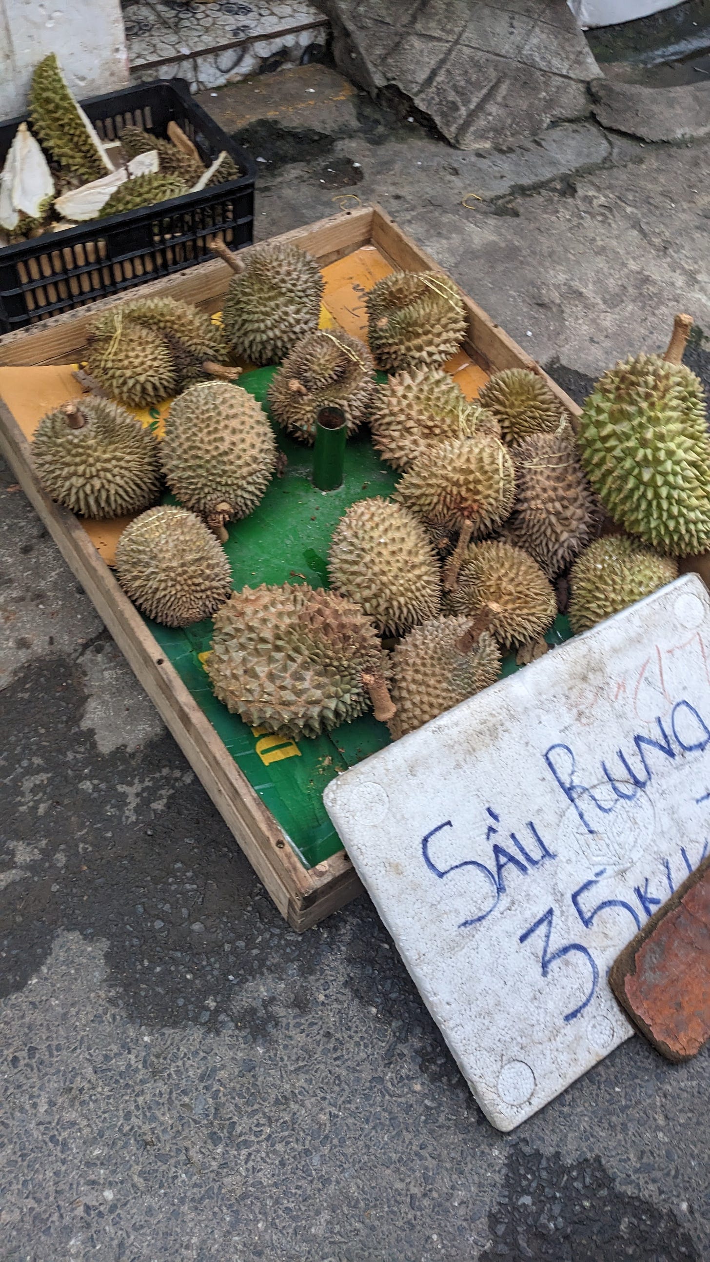 vendor stand of spiky durian fruit