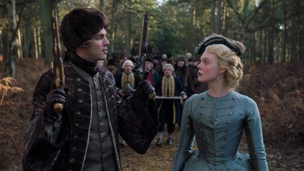 This may contain: a man and woman standing next to each other in the woods