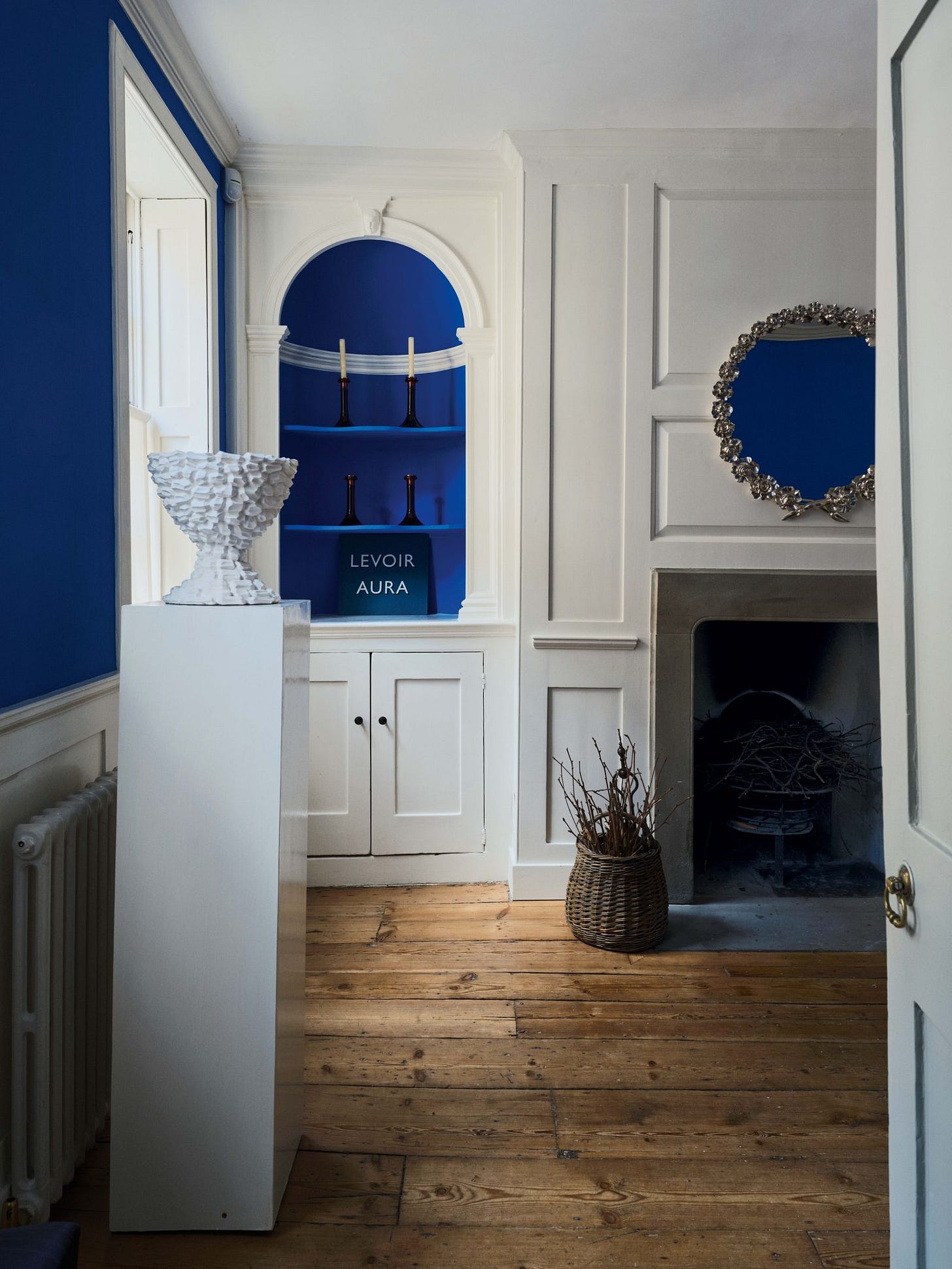 Image may contain Indoors Interior Design Floor Flooring Wood Plant Fireplace Crowd Person and Hardwood