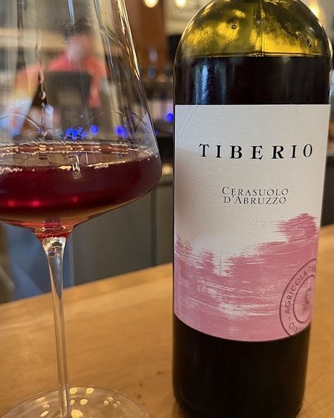 Three wines reviewed: Tiberio Cerasuolo d'Abruzzo poured in a deep pink glass beside its bottle, Approachment 2023 Pinot Meunier Traditional Method Sparkling in a stemmed glass, and Abbey Road Farm 2023 Estate Aligoté poured alongside a plate of dumplings