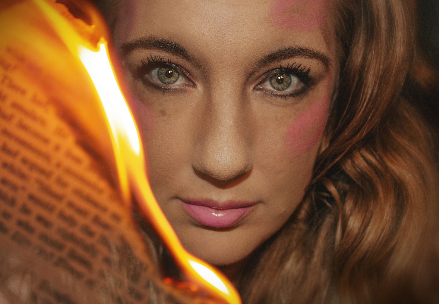 A woman reads her newsletter, but it's on fire