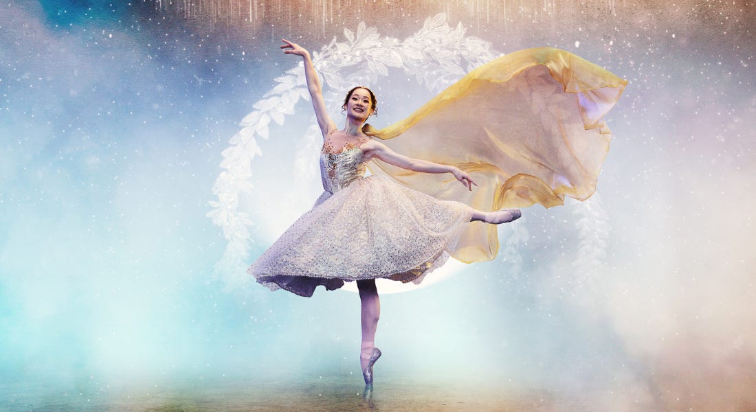 A dancer wearing a white dress on pointed ballet toes, with glittery blue clouds behind her A dancer wearing a white dress on pointed ballet toes, with glittery blue clouds behind her