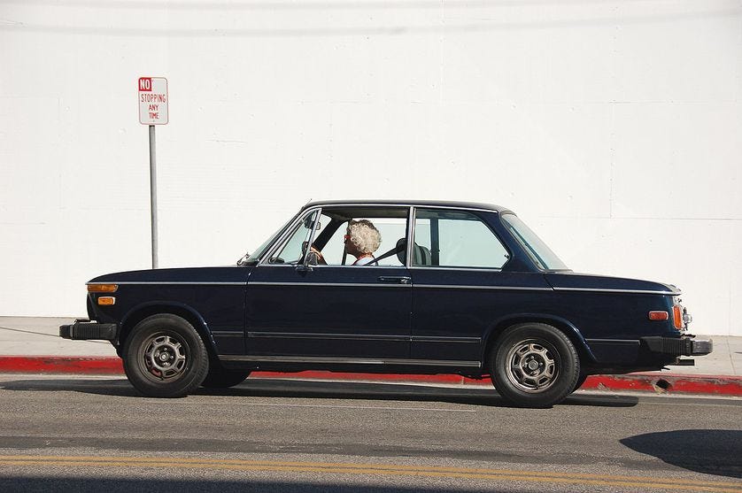 old woman driving old BMW old woman driving old BMW