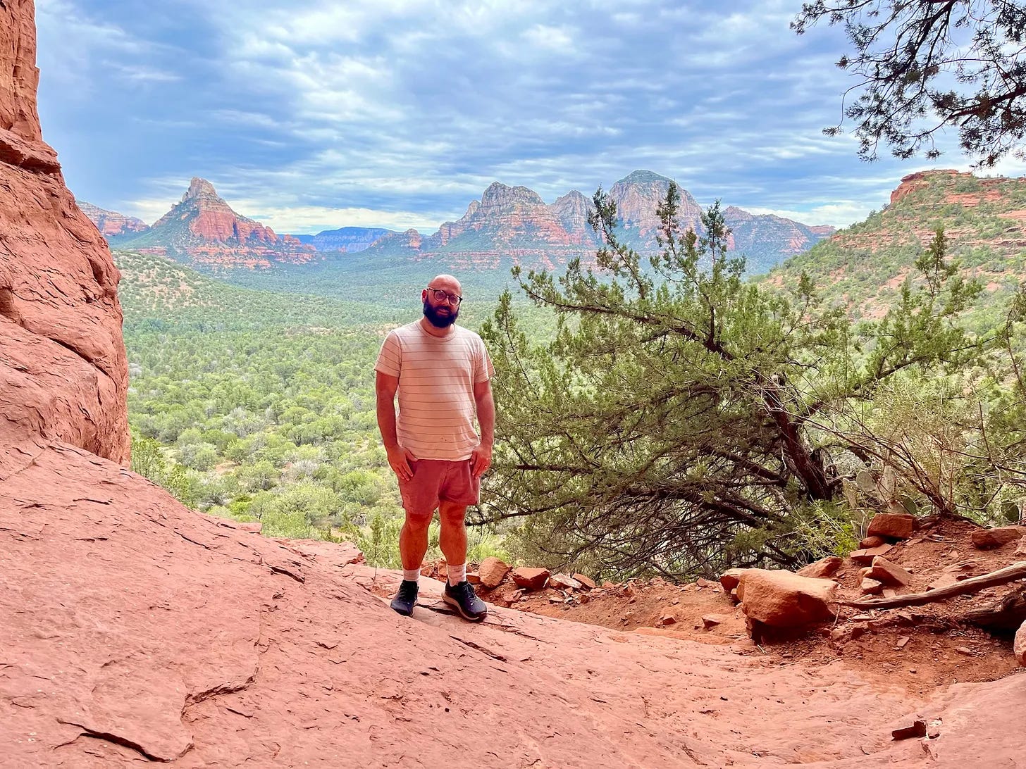 View from inside the Birthing Cave in Sedona, showing the heart-shaped red rock formation and Long Canyon valley