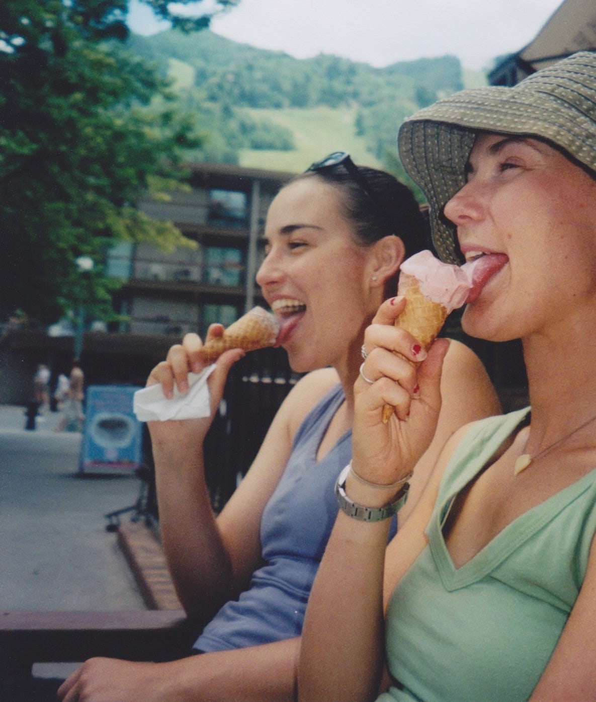 Two friends licking ice cream cones