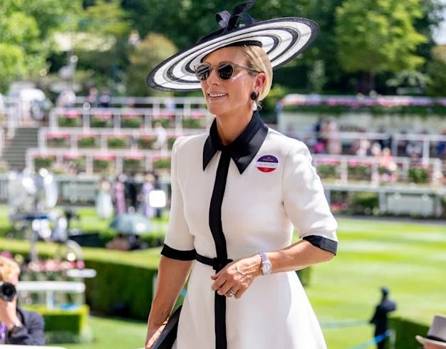 Zara Tindall wearing a white dress and matching black and white fascinator at Royal Ascot