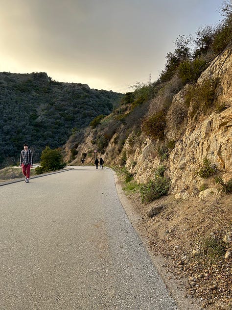 the map of the trails, views from the trails, including the locks on a fence line and the paved path down, and Hannah smiling with the Hollywood sign - pretty far behind her