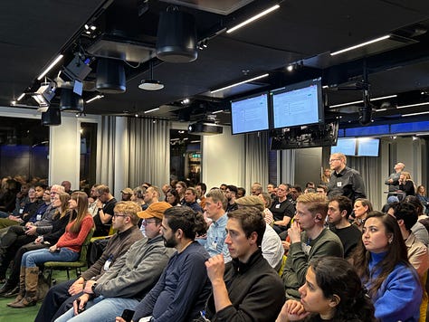 Participants networking, listening to talks, and discussing agents and data engineering during a community night at Google.