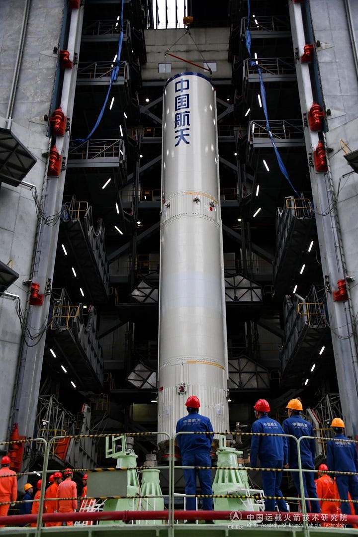 The Long March 3B/E's first-stage and second-stage being placed onto Launch Complex 2 by its rolling vertical assembly building.