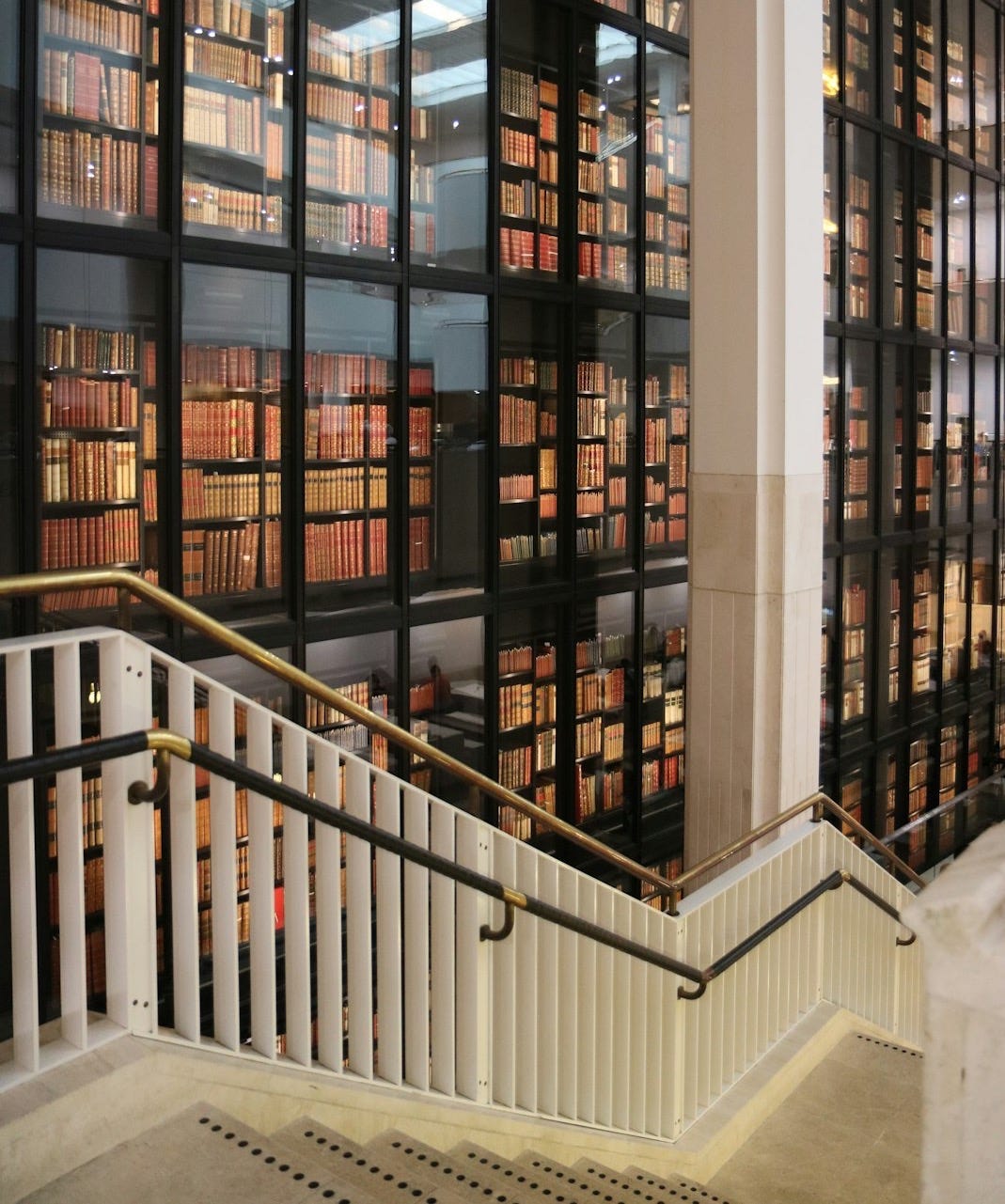 A staircase leading to a library filled with lots of books A staircase leading to a library filled with lots of books