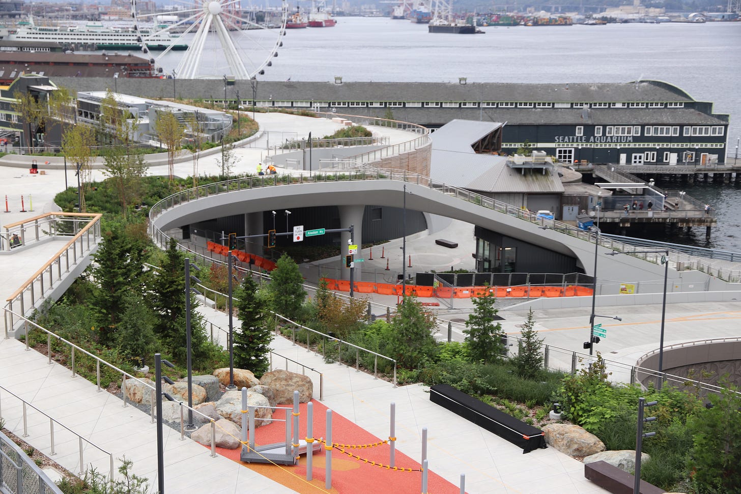 Ramps curve amid planters and descend in stairs in the  Overlook Walk.
