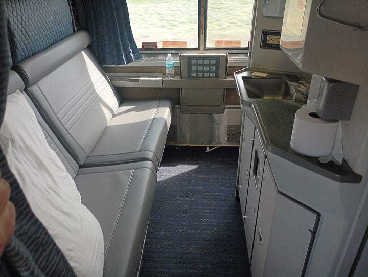 train room with a bath, and roomette, looking at the track behind the last car, looking down the very narrow hallway