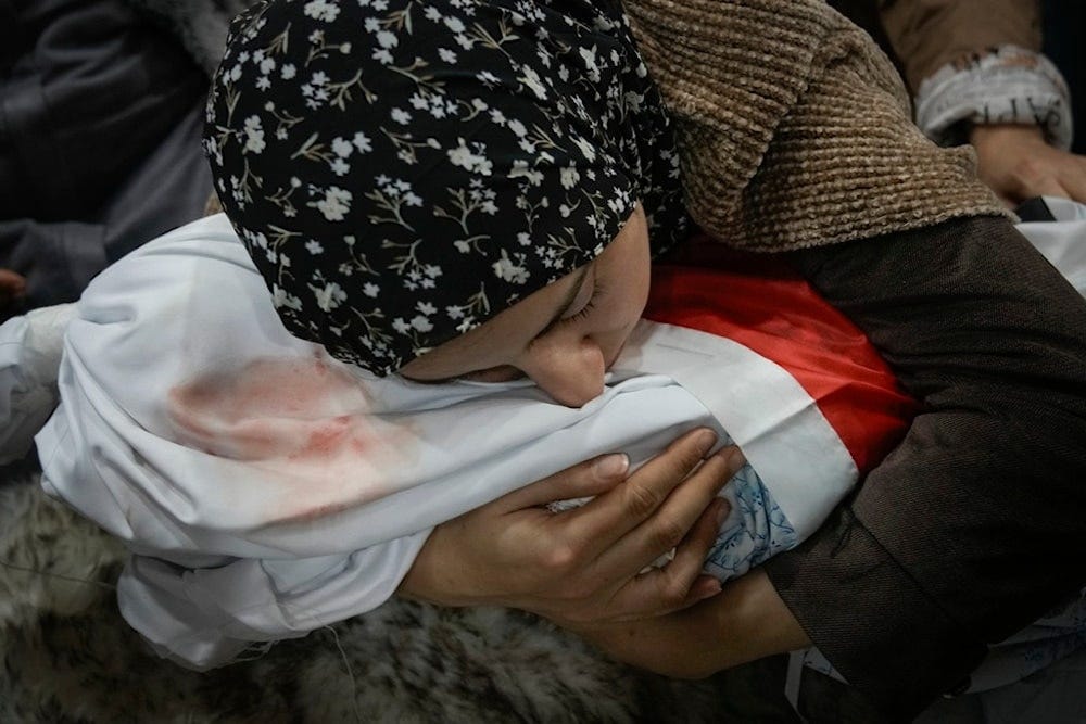 Tima Al-Khatib weeps over the body of her 2-year-old daughter Laila during her funeral in the West Bank village of al-Shuhada, near Jenin, Sunday, January 26, 2025 (AP) Tima Al-Khatib weeps over the body of her 2-year-old daughter Laila during her funeral in the West Bank village of al-Shuhada, near Jenin, Sunday, January 26, 2025 (AP)